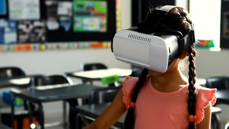 schoolgirl using virtual reality headset in classroom 4k