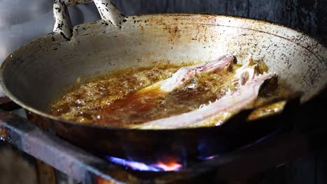 fish sizzling in hot oil on a stovetop