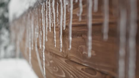 close up of winter stalactite at the wooden barrel.