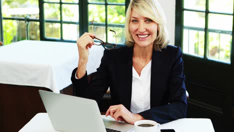 businesswoman using laptop in restaurant 4k