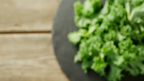 Green-lettuce-leaves-placed-on-wooden-table-4K-4k