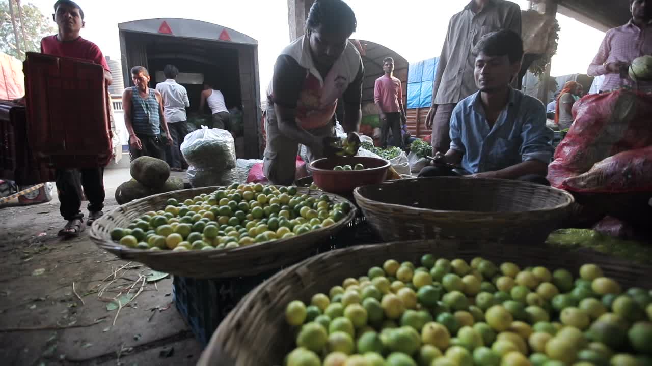 picking lemon from bunch in market