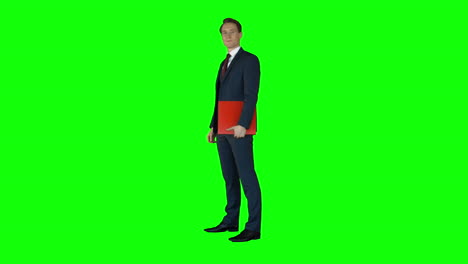 Businessman-standing-on-green-screen-with-red-folder-