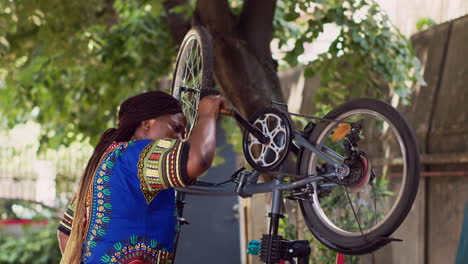 Black-woman-maintaining-bicycle-pedal