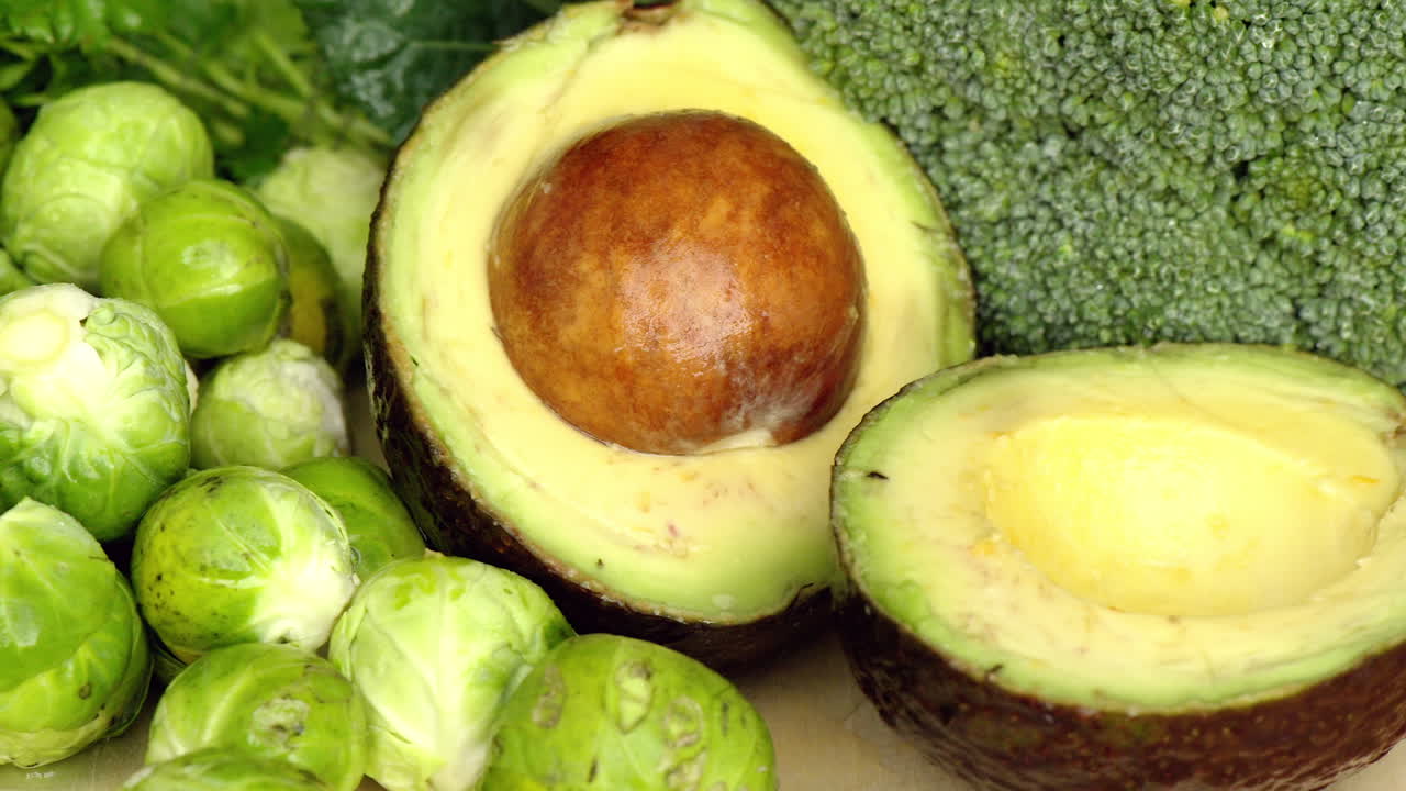 Green composition with avocado and salad, cabbage, macro close up