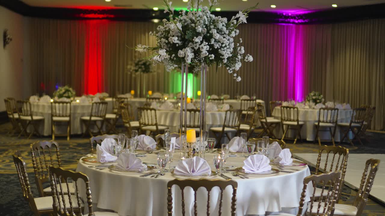 mesa redonda decorada para bodas, pieza central alta con flores de gypsophila paniculate, rosas blancas y follaje verde