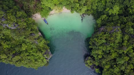 aerial drone flight over paradise island with longtail boat, krabi, thailand