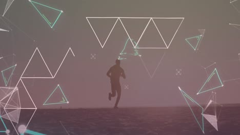 Animation-of-multiple-triangles-over-silhouette-of-african-american-man-running-on-beach