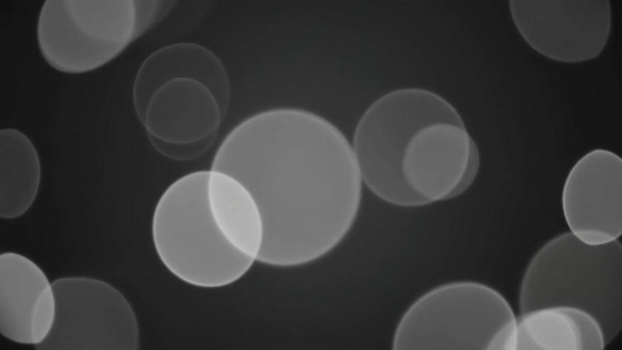 Abstract Background with Floating White Bokeh Circles on Dark Grey