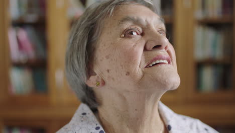 portrait of elderly caucasian woman looking out window thinking of memories pensive contemplative