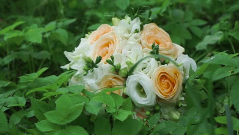 peach and white wedding bouquet in grass