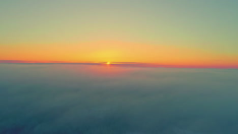drone flying over clouds with yellow sun disappearing