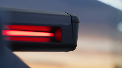 modern car side mirror with red indicator light