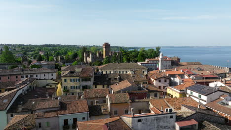 charming village of lazise by lake garda in summer in veneto, italy. - aerialshot