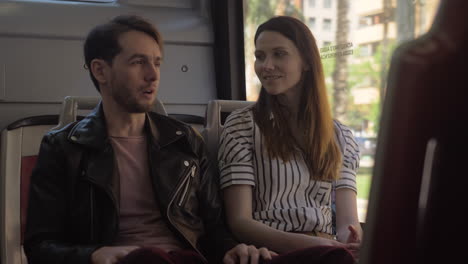 man and woman talking in the bus