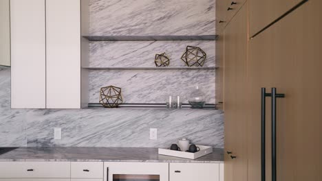 panning shot of modern decorations adorning shelves in a white and luminous kitchen