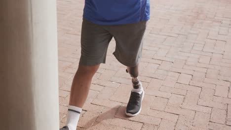 front view man with prosthetic leg stretching