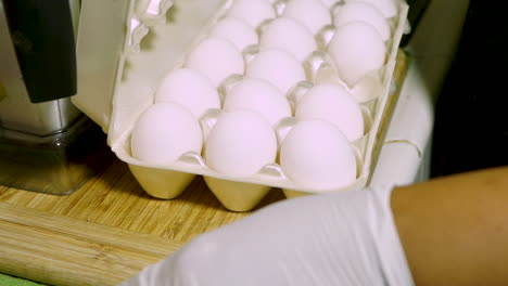 egg carton with white eggs sitting on kitchen counter