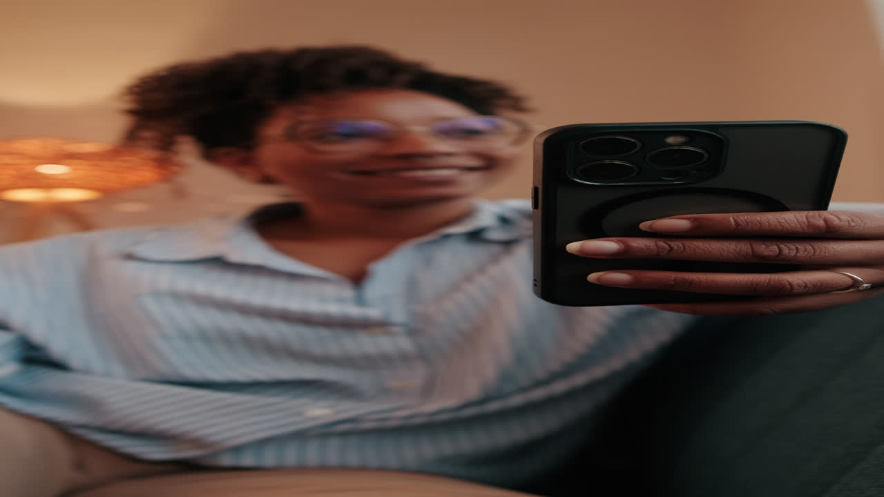 Woman Relaxes on Couch Using Phone