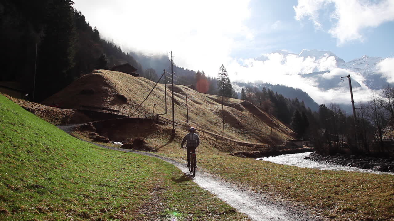 Cyclist going downhill peak Lauterbrunnen Switzerland