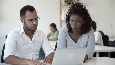 confident african american man talking to colleague at office.