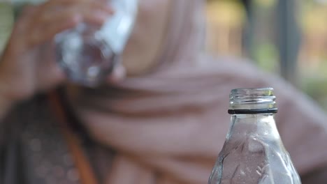 woman drinking water outdoors