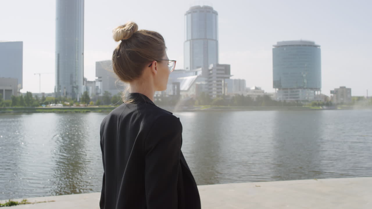 Business Woman Walking Down Sidewalk Near River