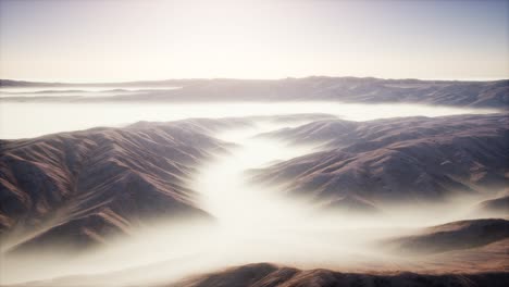 mountain landscape with deep fog at morning