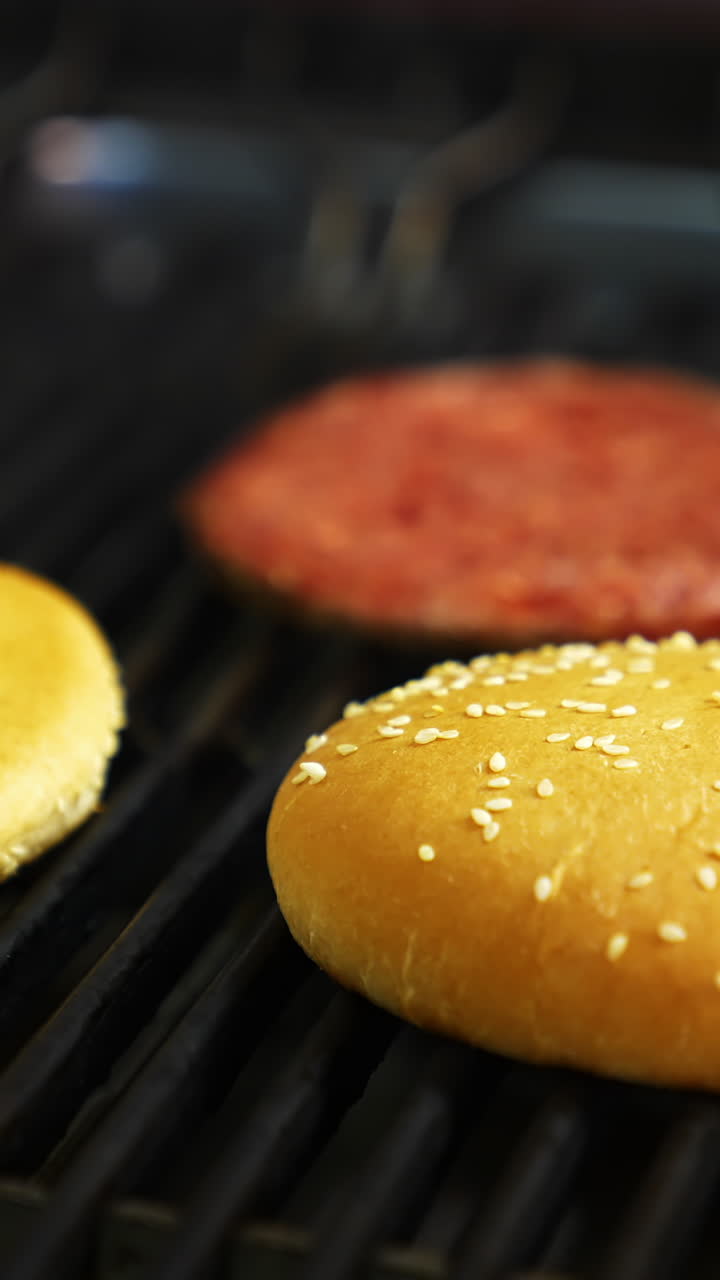 Grilled burger cutlet beef minced meat patties. Cooking beef and pork patty for burger. Raw cutlet burger and two buns. Vertical video