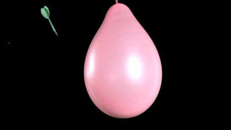 un globo rosado en súper cámara lenta explotando
