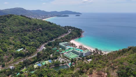 drone footage captures phuket's lush hills and turquoise waters, showcasing luxury resorts and pristine beaches under clear skies