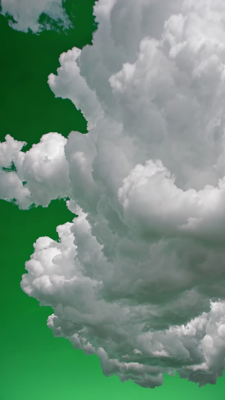 Low-angle shot of fluffy clouds against a vibrant green sky, creating a surreal, dreamlike