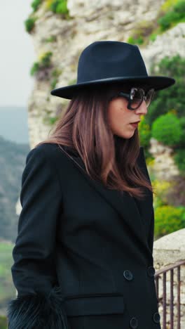 elegant woman with sunglasses and a suggestive natural background behind