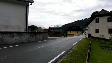slovenia small town surrounded by misty pine forest mountains aerial drone 13