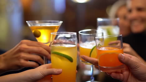 people toasting with cocktails