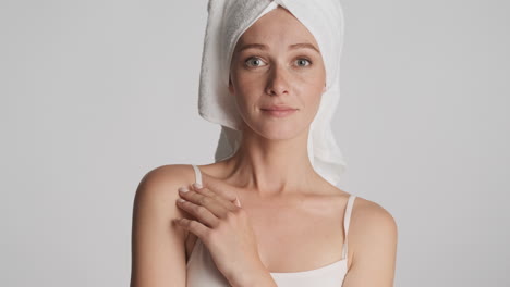 caucasian woman wearing towel on her head.