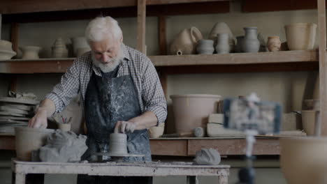 senior potter demonstrating pottery techniques