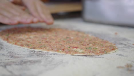 turkish food preparation with ground beef and dough