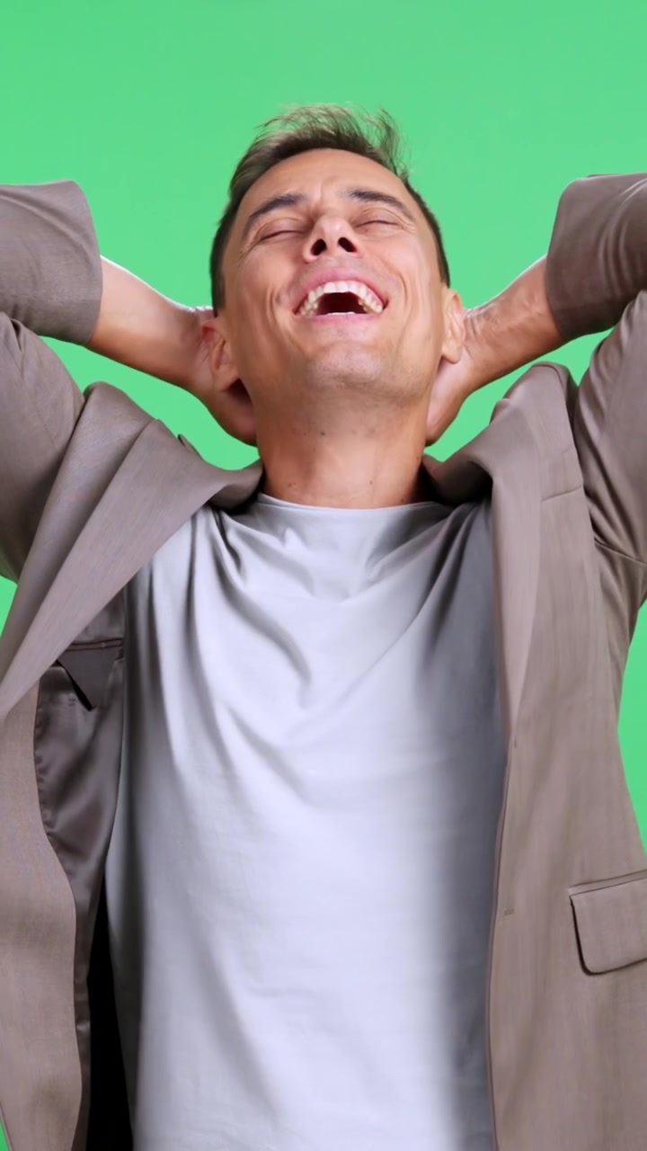 Satisfied businessman relaxing on a green screen background