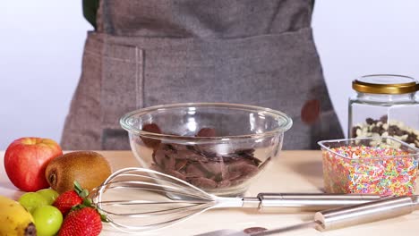 chocolate chips falling into a mixing bowl