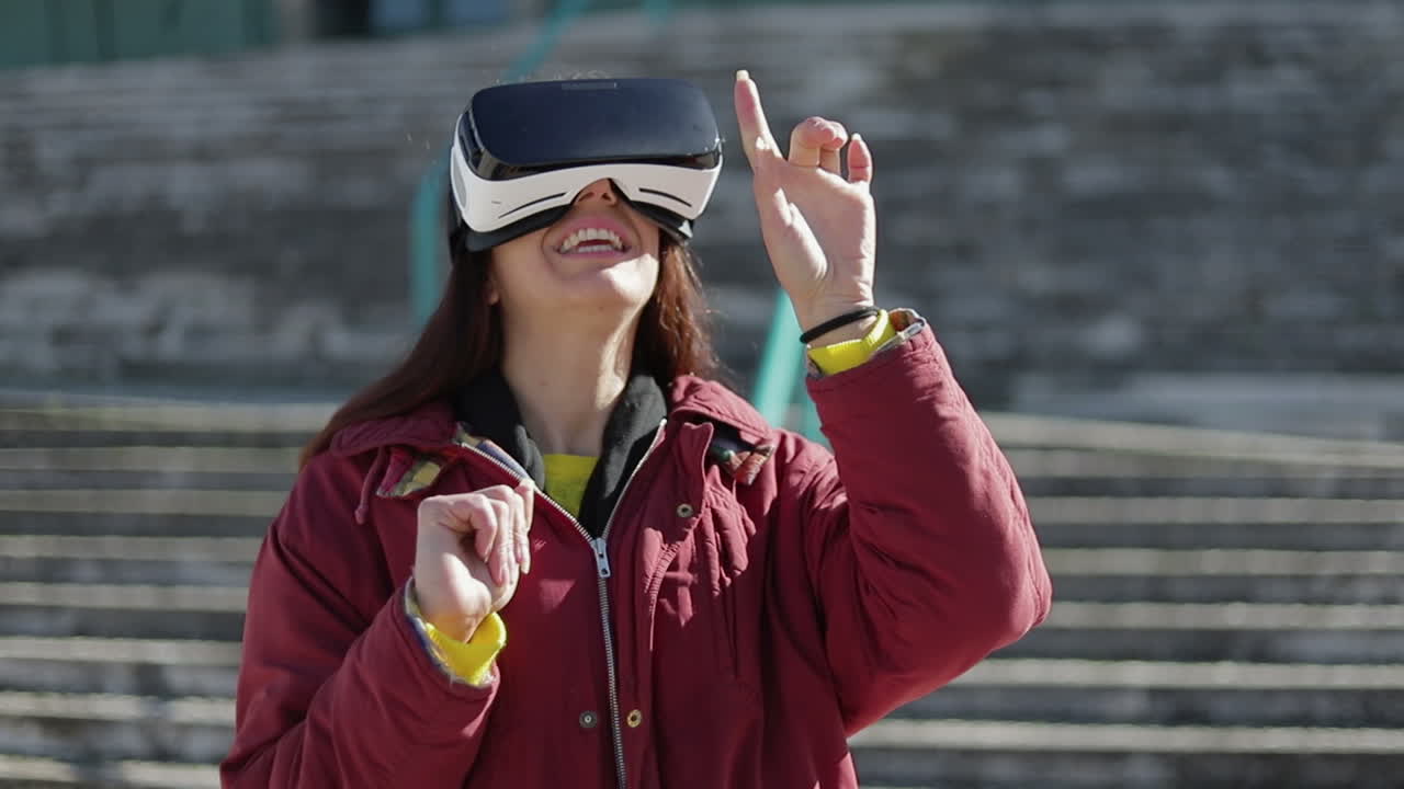 Excited woman with VR headset having fun outdoor