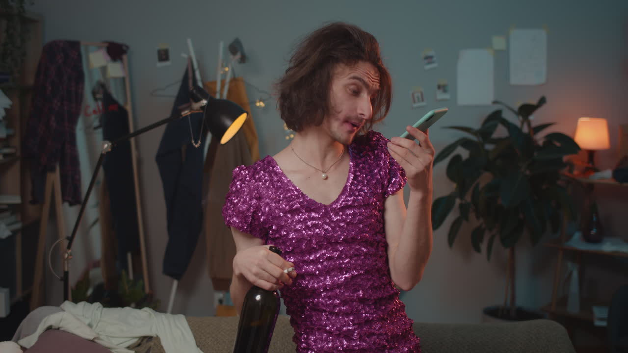 Man in dress talking on phone with wine