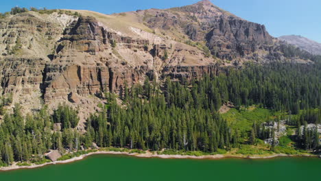 Aerial-video-of-a-mountain-in-the-high-sierras,-camera-tilt-down-to-the-lake-at-30-frames-per-second