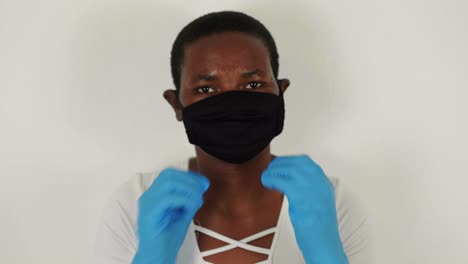 african lady putting on mask for covid-19 prevention