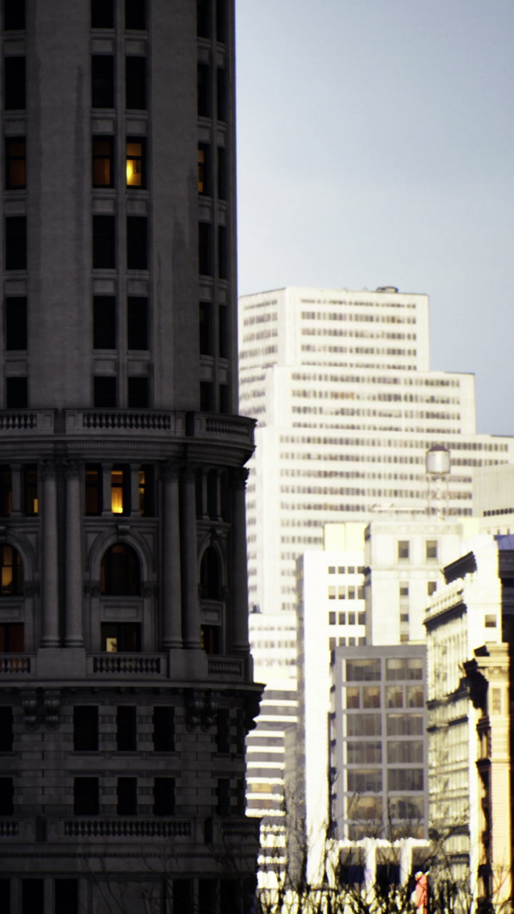City buildings stand close together during evening light in urban landscape
