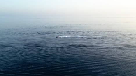 Jet-ski-riding-on-the-sea-at-sunset-on-slow-motion