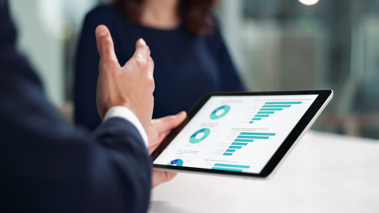 Business meeting with data analysis on tablet