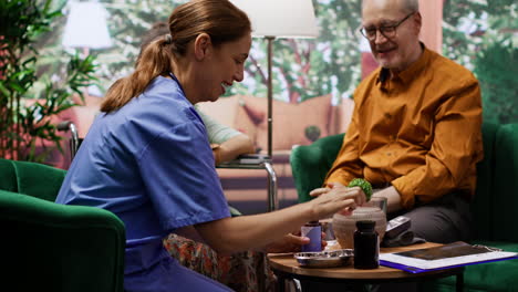 caretaker dividing medicine pills and vitamins for senior man and woman