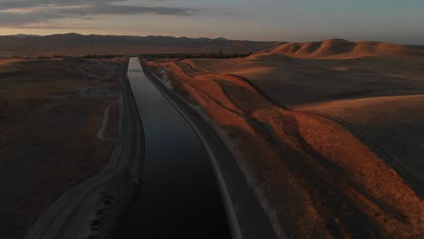 rising aerial of the golden mountains and beautiful sunset shading southern california