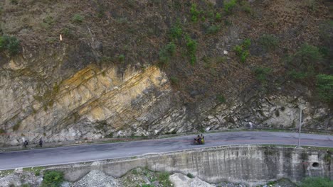 drone shot of a bike and road in himachal pradesh near manali, kasol